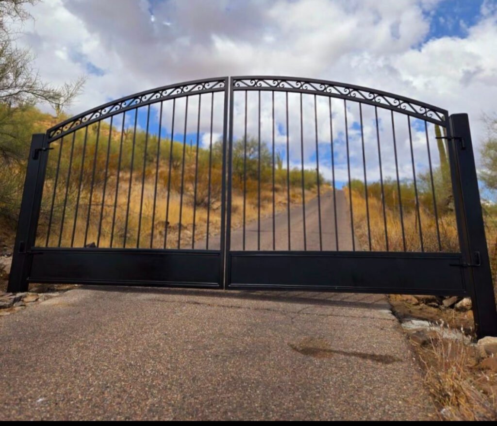 Elegant black wrought iron gate with decorative scrollwork, installed by AAA Garage Door and Gates 